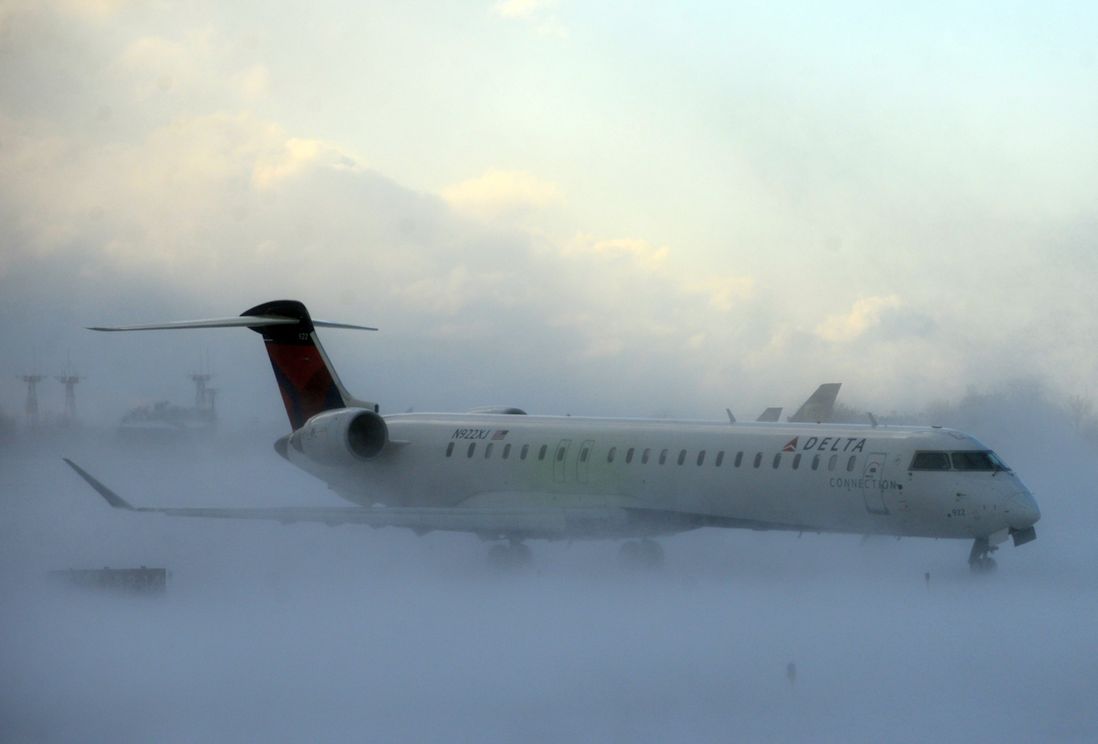 A plane struggles through the snow (AP)